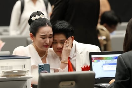 A couple shares an emotional moment after registering their marriage during an event celebrating the implementation of the law A couple shares an emotional moment after registering their marriage during an event celebrating the implementation of the law