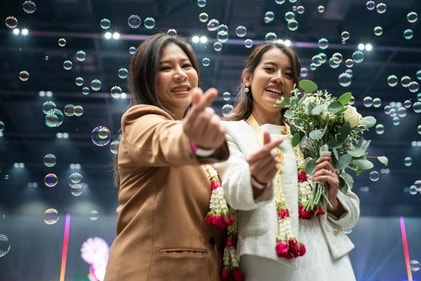 Atchima Pornmuktra (L) and Wipanee Nonthamarn (R), a same-sex couple, pose during their marriage registration event at Paragon shopping mall in Bangkok Atchima Pornmuktra (L) and Wipanee Nonthamarn (R), a same-sex couple, pose during their marriage registration event at Paragon shopping mall in Bangkok