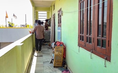 People are seen outside the house of an ex-serviceman, who claimed to have dismembered his wife's body and boiled the parts in a pressure cooker, at a locality in Hyderabad. (PTI) People are seen outside the house of an ex-serviceman, who claimed to have dismembered his wife's body and boiled the parts in a pressure cooker, at a locality in Hyderabad. (PTI)
