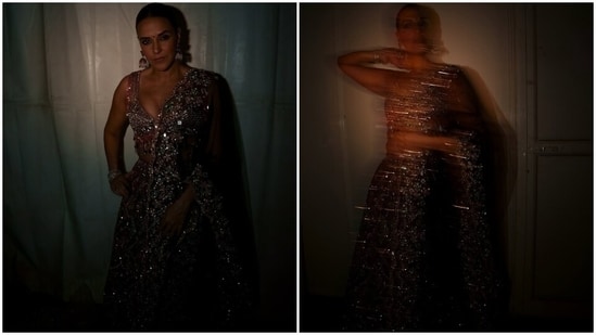 The blouse features a plunging V neckline that flaunted Neha's decolletage. The sleeveless design, mirror embellishments, beaded tassels adorned on the borders and sleeves, a fitted bust, and a cropped midriff-baring hem.&nbsp;