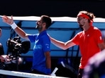 Novak Djokovic shakes hands with the umpire after retiring from his semi final match against Alexander Zverev.