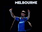 Novak Djokovic gestures to the crowd as he leaves the court.