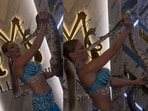 A Russian dancer posed with a giant snake, but it lunged at her face, biting her nose.