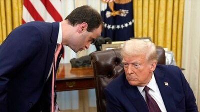 White House staff secretary Will Scharf talks with President Donald Trump after he signed executive orders in the Oval Office of the White House, Thursday, in Washington. (AP) White House staff secretary Will Scharf talks with President Donald Trump after he signed executive orders in the Oval Office of the White House, Thursday, in Washington. (AP)