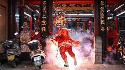Firecrackers are also used in this dance form to make it seem more energetic. ((Photo by JADE GAO / AFP)) Firecrackers are also used in this dance form to make it seem more energetic. ((Photo by JADE GAO / AFP))