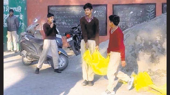 Students carrying sandbags at Government Senior Secondary School for Boys, Jawahar Nagar, in Ludhiana on Friday. (HT Photo)