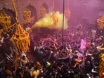 A priest (L) throws coloured powder over Hindu devotees during 'Basant Panchami' festival celebrations, which mark the preparations for the arrival of spring, inside the Sri Bankey Bihari temple in Vrindavan. (File image)