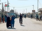 People walk down a street at the Zaatari camp for Syrian refugees, near the Jordanian city of Mafraq, about 80Km north of the capital Amman on January 13, 2025. 