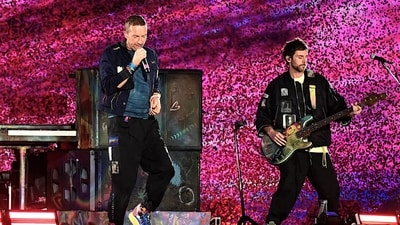 Musician Chris Martin (L) of the British rock band Coldplay, performs onstage during a concert as part of their Music of the Spheres World Tour, at the D.Y. Patil stadium in Navi Mumbai on January 18, 2025. (Photo by SUJIT JAISWAL / AFP) / ----IMAGE RESTRICTED TO EDITORIAL USE - STRICTLY NO COMMERCIAL USE----- (AFP) Musician Chris Martin (L) of the British rock band Coldplay, performs onstage during a concert as part of their Music of the Spheres World Tour, at the D.Y. Patil stadium in Navi Mumbai on January 18, 2025. (Photo by SUJIT JAISWAL / AFP) / ----IMAGE RESTRICTED TO EDITORIAL USE - STRICTLY NO COMMERCIAL USE----- (AFP)