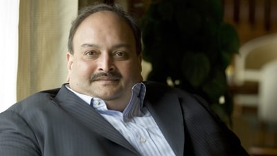 Mehul Choksi is a fugitive Indian businessman and the owner of Gitanjali Group is wanted by Indian authorities in the Punjab National Bank (PNB) scam where it is alleged that the Choksi-Nirav Modi duo defrauded the bank of more than <span class='webrupee'>₹</span>14,000 crore. India has sought Choksi's extradition and the authorities said they are working on the process so that Choksi can be held and eventually brought to India. (Mint) Mehul Choksi is a fugitive Indian businessman and the owner of Gitanjali Group is wanted by Indian authorities in the Punjab National Bank (PNB) scam where it is alleged that the Choksi-Nirav Modi duo defrauded the bank of more than <span class='webrupee'>₹</span>14,000 crore. India has sought Choksi's extradition and the authorities said they are working on the process so that Choksi can be held and eventually brought to India. (Mint)