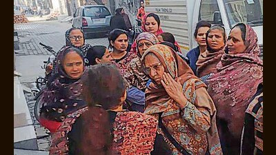 Neighbours outside the victim’s house after the attack on Saturday. (HT Photo) Neighbours outside the victim’s house after the attack on Saturday. (HT Photo)