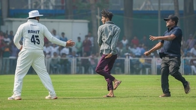Rohit Sharma being greeted by a pitch invader on the third day of Ranji trophy (PTI) Rohit Sharma being greeted by a pitch invader on the third day of Ranji trophy (PTI)