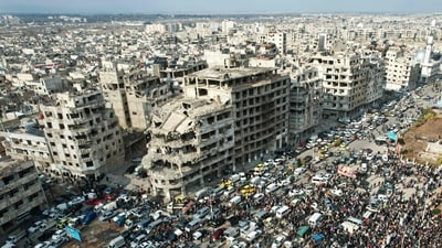 This aerial photo shows Syrians gathering near a destroyed building in the central city of Homs as they celebrate the fall of Bashar al-Assad's iron-fisted rule. (AFP) This aerial photo shows Syrians gathering near a destroyed building in the central city of Homs as they celebrate the fall of Bashar al-Assad's iron-fisted rule. (AFP)