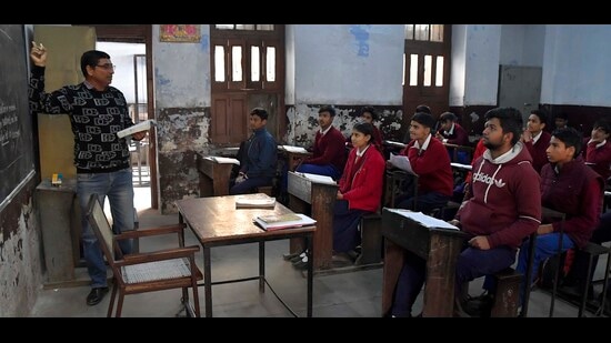 Students attending a class at a government-aided school in Ludhiana on Saturday. (Manish/HT)