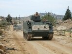 Lebanese army vehicles drive past destroyed buildings in the southern Lebanese village of Yarin on January 26, 2025. Lebanese army vehicles drive past destroyed buildings in the southern Lebanese village of Yarin on January 26, 2025.