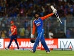 India's Tilak Varma celebrates after hitting four runs to win the game.