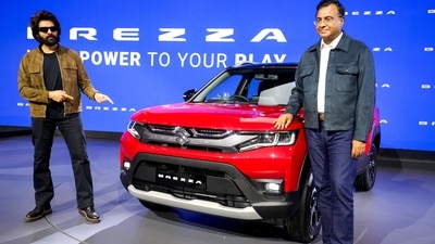 Bollywood actor Kartik Aaryan, left, poses for photographs next to a Brezza model at the Maruti stall during Bharat Mobility Global Expo 2025, in New Delhi. (PTI) Bollywood actor Kartik Aaryan, left, poses for photographs next to a Brezza model at the Maruti stall during Bharat Mobility Global Expo 2025, in New Delhi. (PTI)