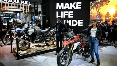 A model stands next to a BMW motorcycle displayed at the Bharat Mobility Global Expo 2025, in New Delhi. (AFP) A model stands next to a BMW motorcycle displayed at the Bharat Mobility Global Expo 2025, in New Delhi. (AFP)