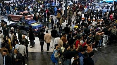 People look at cars displayed at the Bharat Mobility Global Expo 2025, in New Delhi. (AFP) People look at cars displayed at the Bharat Mobility Global Expo 2025, in New Delhi. (AFP)