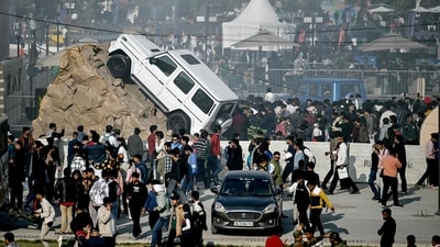 People walk past cars displayed at the Bharat Mobility Global Expo 2025, in New Delhi. (AFP) People walk past cars displayed at the Bharat Mobility Global Expo 2025, in New Delhi. (AFP)