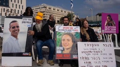 Families and supporters of Israeli hostages held by Hamas in Gaza, hold photos of their loved ones during a protest calling for their release outside the prime minister's office in Jerusalem, Sunday, Jan. 26, 2025. (AP)
