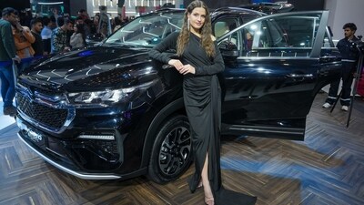 A model poses with a Maruti car at the Bharat Mobility Global Expo 2025, in New Delhi. (PTI) A model poses with a Maruti car at the Bharat Mobility Global Expo 2025, in New Delhi. (PTI)