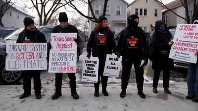 Activists with Revcom Corps Chicago hold signs outside of Hamline Elementary School after federal agents were turned away in Chicago. (AP/File) Activists with Revcom Corps Chicago hold signs outside of Hamline Elementary School after federal agents were turned away in Chicago. (AP/File)