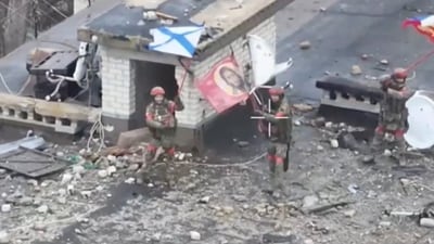 A drone view shows Russian service members waving flags on the roof of a building in the course of Russia-Ukraine conflict in the settlement of Velyka Novosilka in the Donetsk region, a Russian-controlled part of Ukraine, in this still image from video released January 26, 2025. (via REUTERS)