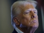 FILE PHOTO: U.S. President Donald Trump looks on as reporters ask questions aboard Air Force One during a flight from Las Vegas, Nevada, to Miami, Florida.