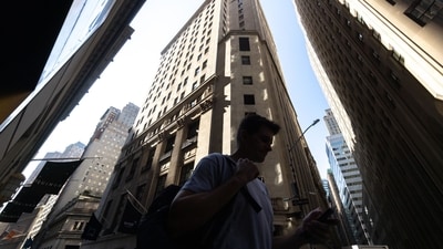 Pedestrians walk along Wall Street near the New York Stock Exchange (NYSE) in New York, US. (Bloomberg) Pedestrians walk along Wall Street near the New York Stock Exchange (NYSE) in New York, US. (Bloomberg)