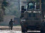 An Israeli soldier gestures during a raid on the Jenin camp for Palestinian refugees