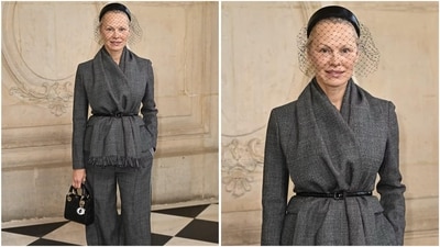 Pamela Anderson stunned in a monochrome gray wool look, featuring wide-leg trousers and a draped jacket with long sleeves, complemented by a chic birdcage veil. (AP photo) Pamela Anderson stunned in a monochrome gray wool look, featuring wide-leg trousers and a draped jacket with long sleeves, complemented by a chic birdcage veil. (AP photo)
