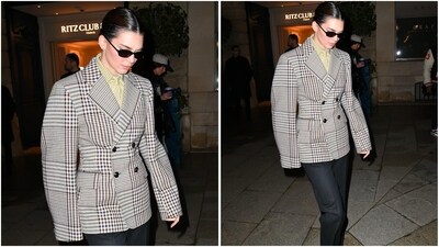 After the show, Kendall Jenner stepped out in style, rocking a plaid blazer with oversized sleeves layered over a leopard-striped shirt. She paired it with black trousers and sunglasses for a chic finish. (AP photo) After the show, Kendall Jenner stepped out in style, rocking a plaid blazer with oversized sleeves layered over a leopard-striped shirt. She paired it with black trousers and sunglasses for a chic finish. (AP photo)
