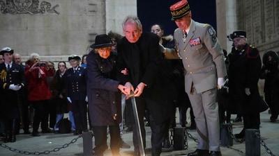 A French holocaust survivor along with France's Prime Minister Francois Bayrou and others took part in the Rekindling the Flame ceremony at the Tomb of the Unknown Soldier during at the Arc de Triomphe in Paris in honour of International Holocaust Remembrance Day (Dimitar Dilkoff / AFP) A French holocaust survivor along with France's Prime Minister Francois Bayrou and others took part in the Rekindling the Flame ceremony at the Tomb of the Unknown Soldier during at the Arc de Triomphe in Paris in honour of International Holocaust Remembrance Day (Dimitar Dilkoff / AFP)