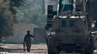 An Israeli soldier gestures during a raid on the Jenin camp for Palestinian refugees (AFP) An Israeli soldier gestures during a raid on the Jenin camp for Palestinian refugees (AFP)