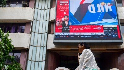 Mumbai: A woman walks past the Bombay Stock Exchange (BSE) building, in Mumbai, Monday, Aug. 5, 2024. (PTI) Mumbai: A woman walks past the Bombay Stock Exchange (BSE) building, in Mumbai, Monday, Aug. 5, 2024. (PTI)
