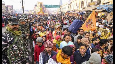 Security personnel stand guard as devotees visit the Hanuman Garhi Temple after taking a holy dip in Sarayu river, in Ayodhya, Tuesday (PTI) Security personnel stand guard as devotees visit the Hanuman Garhi Temple after taking a holy dip in Sarayu river, in Ayodhya, Tuesday (PTI)