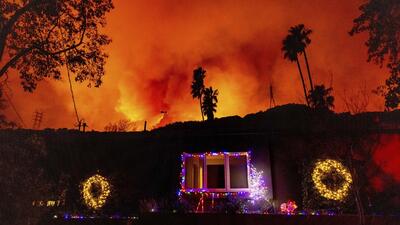 A helicopter drops water on the Palisades Fire in Los Angeles (AP) A helicopter drops water on the Palisades Fire in Los Angeles (AP)