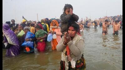 Devotees arrive to take a holy dip at Sangam on Mauni Amavasya during the ongoing Mahakumbh Mela, in Prayagraj, Wednesday. (PTI Photo)