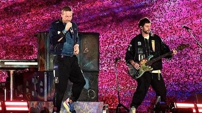 Musician Chris Martin (L) of the British band Coldplay, performs onstage during a concert at the D.Y. Patil stadium in Navi Mumbai. (AFP) Musician Chris Martin (L) of the British band Coldplay, performs onstage during a concert at the D.Y. Patil stadium in Navi Mumbai. (AFP)