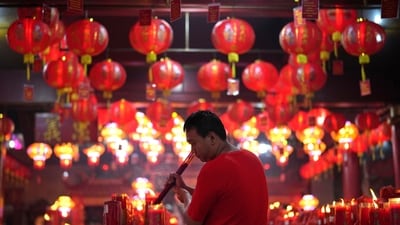 A man lights joss sticks during the celebration of the Lunar New Year of the Snake at Hok Lay Kiong Temple in Bekasi, Indonesia, Wednesday. The auspicious festival of Lunar New Year is celebrated with pomp by East Asian communities around the globe, especially in countries like China, Taiwan, Hong Kong, Macau, Singapore, Vietnam, and South Korea. (AP)