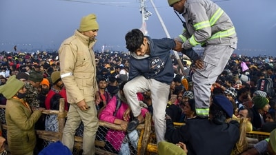 Security and UP Fire and Emergency Services personnel help a boy during a stampede-like situation on 'Mauni Amavasya', at the ongoing Maha Kumbh Mela. (PTI) Security and UP Fire and Emergency Services personnel help a boy during a stampede-like situation on 'Mauni Amavasya', at the ongoing Maha Kumbh Mela. (PTI)