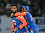 India's Varun Chakaravarthy (L) celebrates with captain Suryakumar Yadav after taking a wicket.