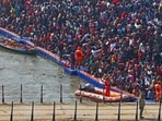 Devotees gather to take a holy dip in the sacred waters of Sangam on the occasion of 'Mauni Amavasya' during the Maha Kumbh Mela festival, in Prayagraj on January 29, 2025.
