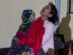 Wife of Amit Kumar, a man from Haryana who died in the early morning stampede during the Maha Kumbh, weeps holding her child outside a mortuary in Prayagraj on Wednesday. (AP)