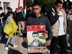 A Palestinian youth holds a portrait of Zakaria Zubeidi, a leader of Al-Aqsa Martys Brigades, as people gathered in Ramallah to receive released Palestinian prisoners from Israeli jails in the occupied West Bank as part of a third hostage-prisoner exchange between Israel and Hamas on January 30, 2025. A Palestinian youth holds a portrait of Zakaria Zubeidi, a leader of Al-Aqsa Martys Brigades, as people gathered in Ramallah to receive released Palestinian prisoners from Israeli jails in the occupied West Bank as part of a third hostage-prisoner exchange between Israel and Hamas on January 30, 2025.