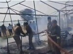 Fire department officers on-site using extinguishers to douse the blaze that erupted outside Sector 22 in the Maha Kumbh Mela area  on Thursday.