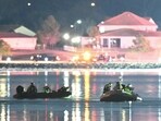Rescue boats search the waters of the Potomac River after a plane on approach to Reagan National Airport crashed into the river outside Washington, DC.