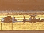 Part of the wreckage is seen as rescue boats search the waters of the Potomac River after a plane on approach to Reagan National Airport crashed into the river near Washington, DC, on January 30, 2025. (Photo by Andrew CABALLERO-REYNOLDS / AFP)