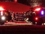 Bodies are transported next to emergency vehicles, near the site of the crash after American Eagle flight 5342 collided with a Black Hawk helicopter while approaching Reagan Washington National Airport and crashed into the Potomac River, outside Washington, U.S., January 30, 2025. REUTERS/Carlos Barria